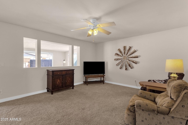 living area with ceiling fan, carpet flooring, and baseboards