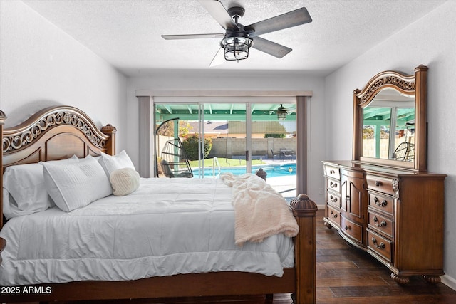 bedroom featuring multiple windows, a textured ceiling, access to exterior, and dark hardwood / wood-style flooring