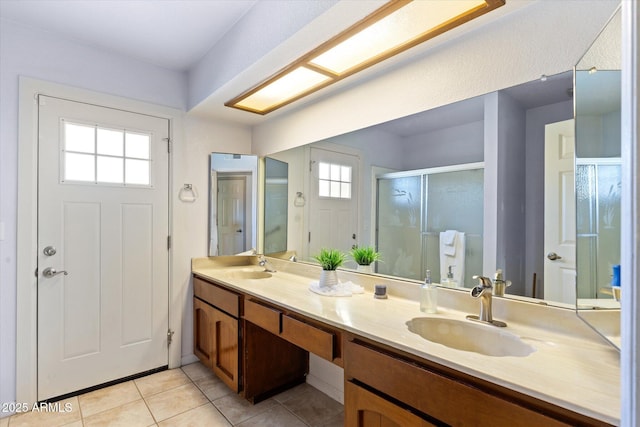 bathroom with vanity, plenty of natural light, tile patterned floors, and walk in shower