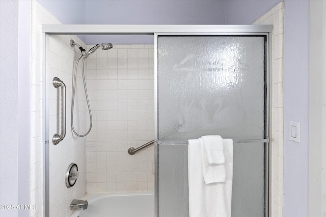 bathroom featuring shower / bath combination with glass door