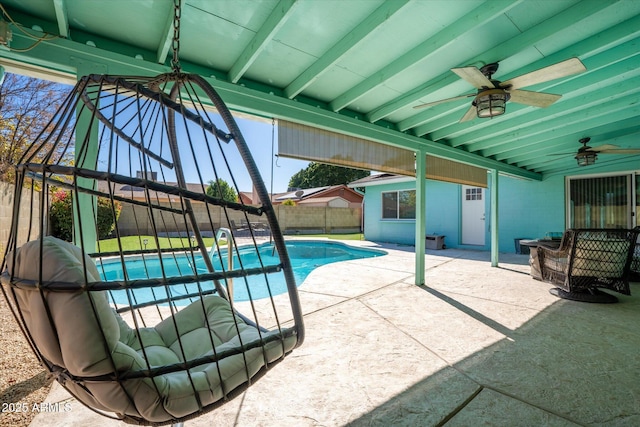 view of swimming pool featuring ceiling fan and a patio area