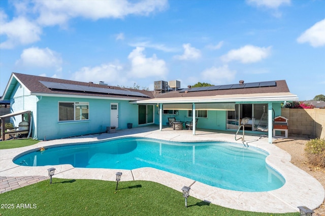 view of pool featuring cooling unit and a patio