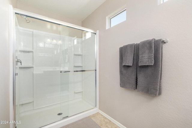 bathroom with a shower with shower door