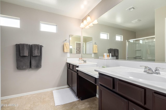 bathroom featuring plenty of natural light, an enclosed shower, and vanity