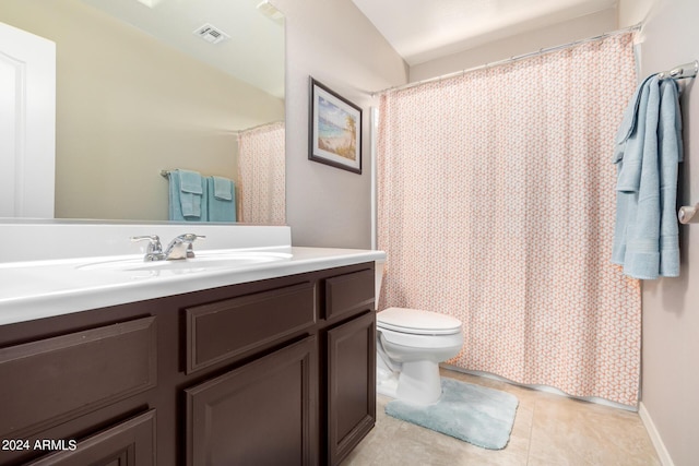 bathroom featuring tile patterned floors, vanity, and toilet