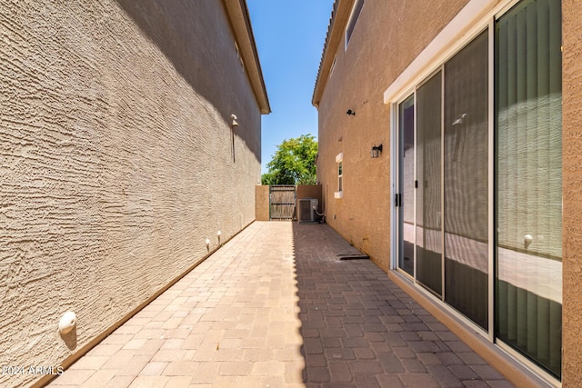 view of side of home with a patio and central AC