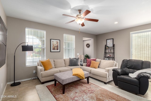 tiled living room with ceiling fan