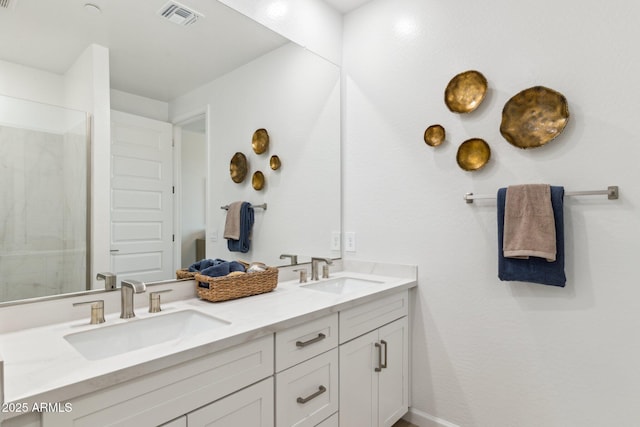 bathroom featuring double vanity, walk in shower, a sink, and visible vents