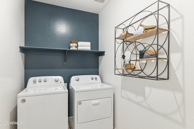 clothes washing area featuring laundry area, visible vents, and separate washer and dryer