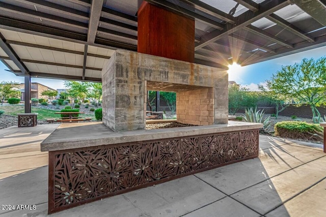 view of patio with exterior fireplace