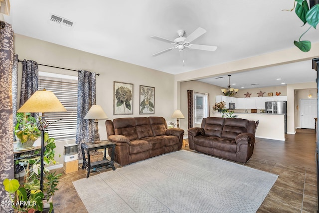 living room with recessed lighting, visible vents, and ceiling fan with notable chandelier