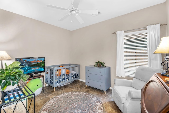 bedroom featuring baseboards, a ceiling fan, and visible vents