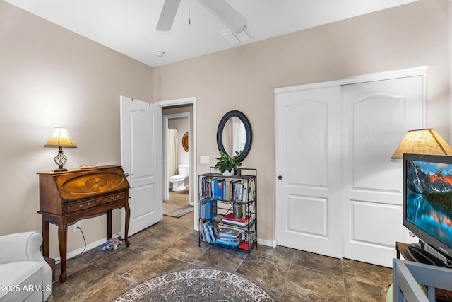 interior space featuring visible vents, stone finish flooring, ceiling fan, and baseboards