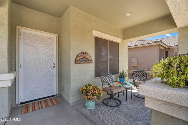 property entrance featuring stucco siding
