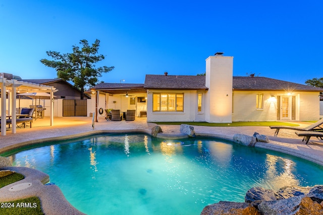 pool at dusk with a patio