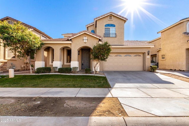 mediterranean / spanish house with a garage and a front lawn