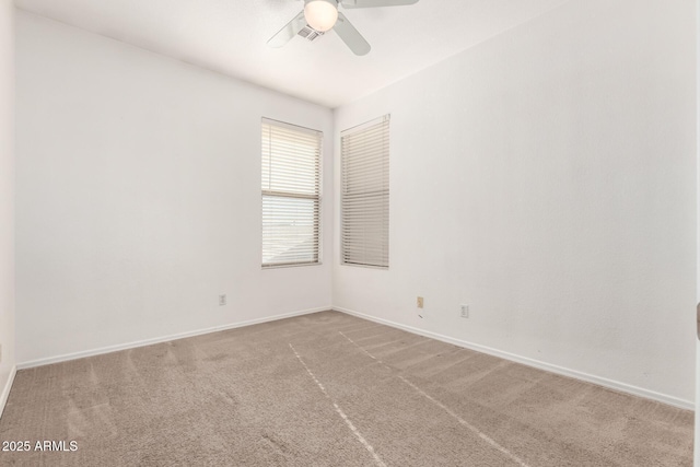 empty room featuring ceiling fan and carpet floors