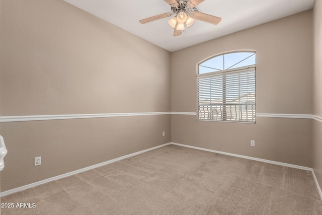 carpeted spare room featuring ceiling fan