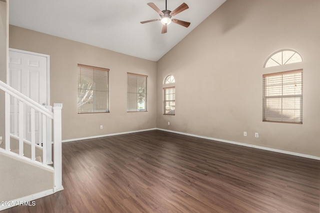 unfurnished room with dark hardwood / wood-style flooring, plenty of natural light, high vaulted ceiling, and ceiling fan