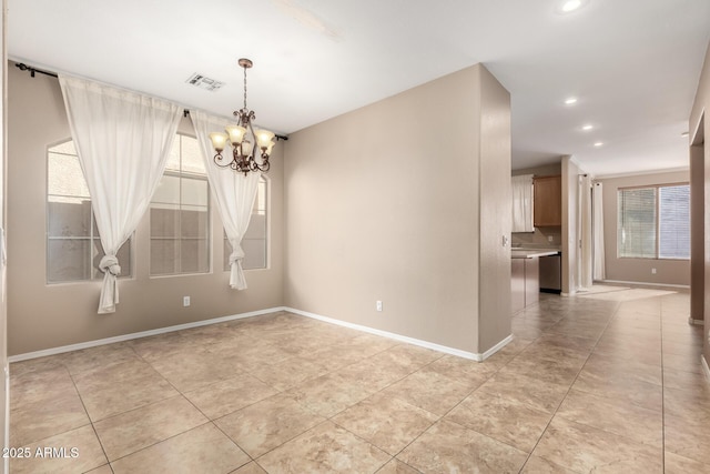 unfurnished room with a chandelier and light tile patterned floors