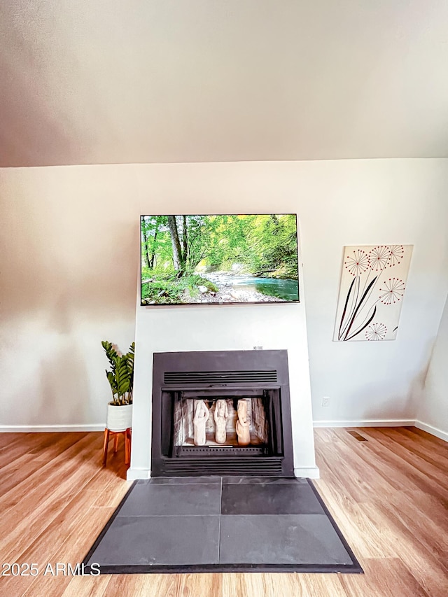 2124 Forest Park Dr, Overgaard, AZ 85933 - details featuring wood finished floors, a fireplace with flush hearth, and baseboards