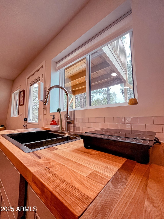 2124 Forest Park Dr, Overgaard, AZ 85933 - kitchen with tasteful backsplash, wooden counters, a sink, and wood finished floors