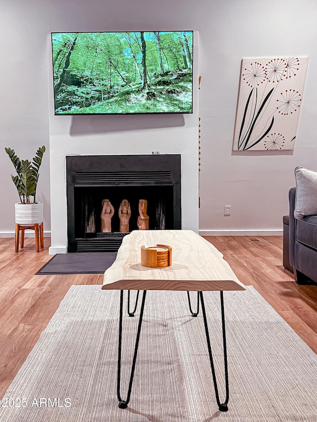 2124 Forest Park Dr, Overgaard, AZ 85933 - living area with a fireplace with flush hearth, baseboards, and wood finished floors