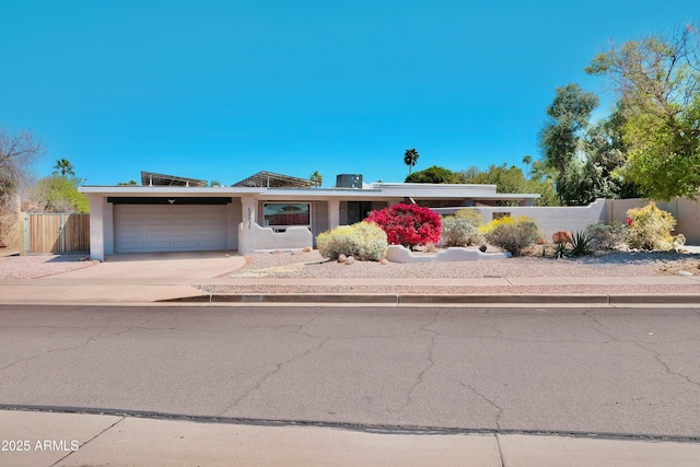 11035 N 37th St, Phoenix, AZ 85028 - view of front facade featuring fence, an attached garage, driveway, and stucco siding