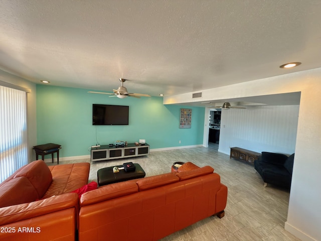 11035 N 37th St, Phoenix, AZ 85028 - living area featuring a textured ceiling, baseboards, a ceiling fan, and visible vents