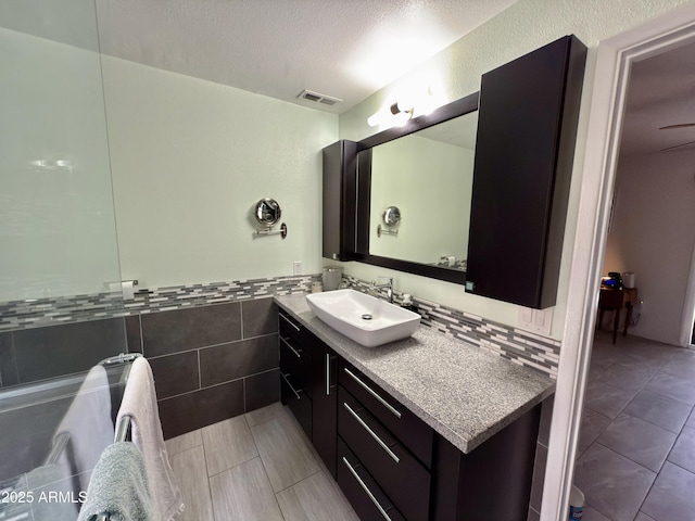 11035 N 37th St, Phoenix, AZ 85028 - bathroom with tile walls, a wainscoted wall, vanity, visible vents, and tile patterned floors