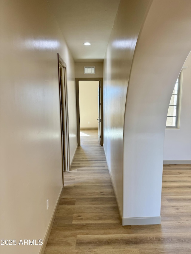 corridor featuring recessed lighting, light wood-type flooring, visible vents, and baseboards