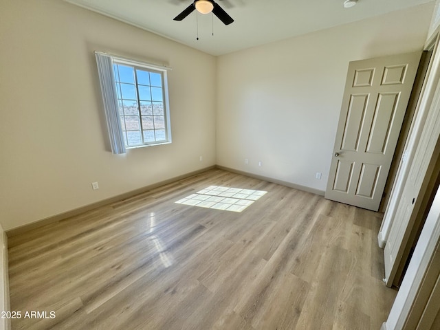 unfurnished bedroom featuring light wood-style floors, baseboards, and a ceiling fan