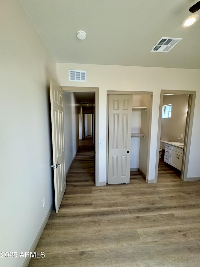 unfurnished bedroom with baseboards, visible vents, and light wood finished floors