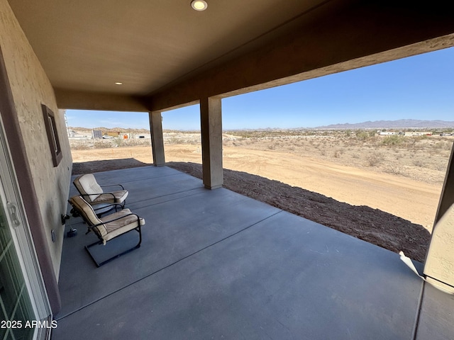 view of patio / terrace featuring a mountain view