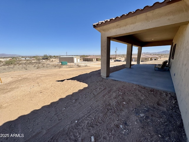 view of yard featuring a patio and an outdoor structure