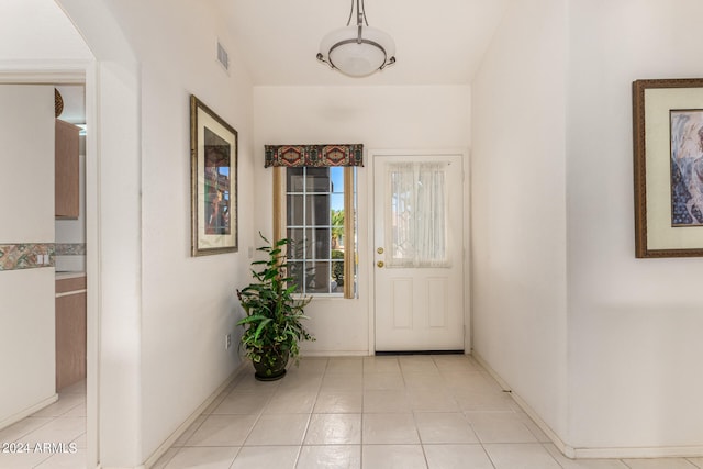 doorway with light tile patterned flooring