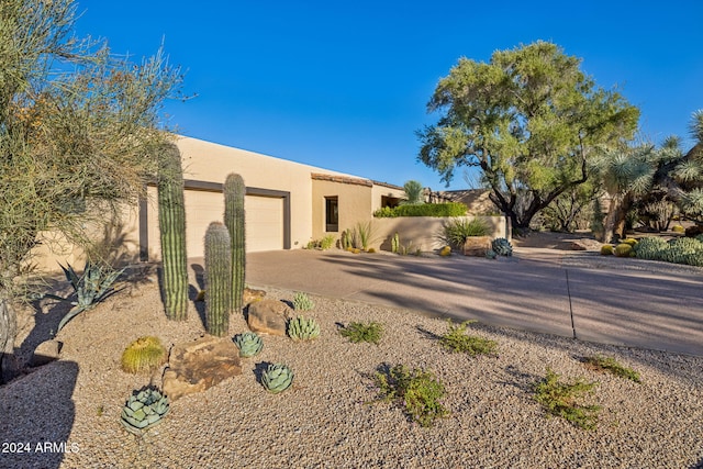 pueblo-style house with a garage