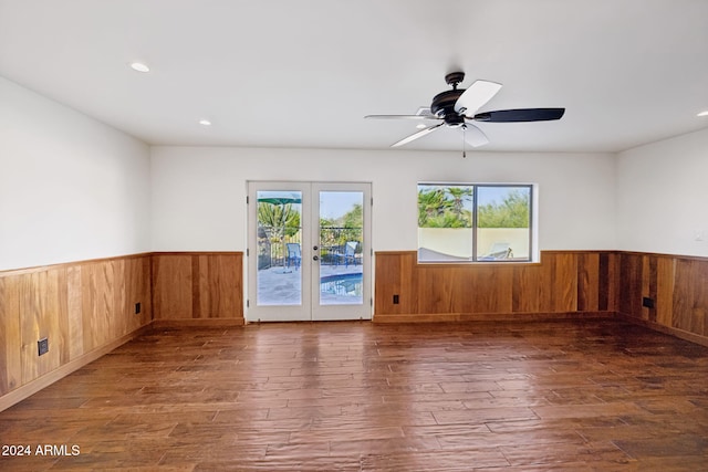 unfurnished room featuring french doors, plenty of natural light, and dark hardwood / wood-style flooring