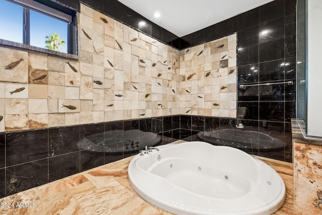 bathroom featuring tile walls and tiled tub