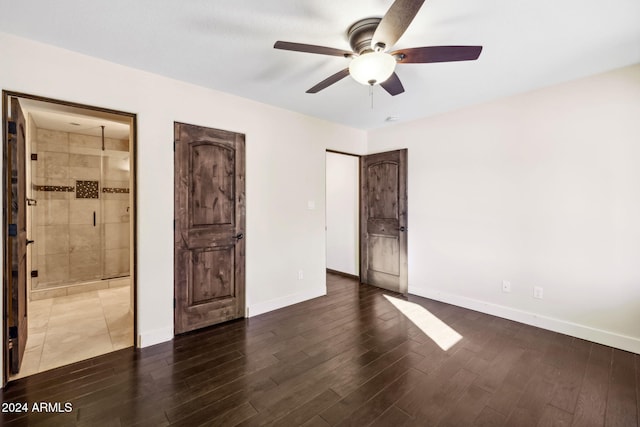 unfurnished bedroom with ceiling fan, ensuite bathroom, and dark hardwood / wood-style flooring