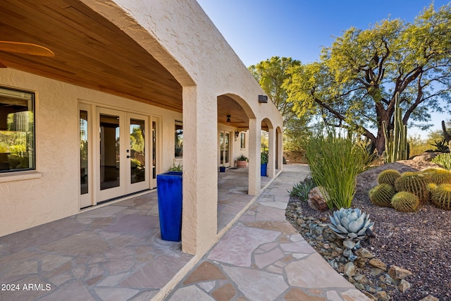 view of patio with french doors and ceiling fan