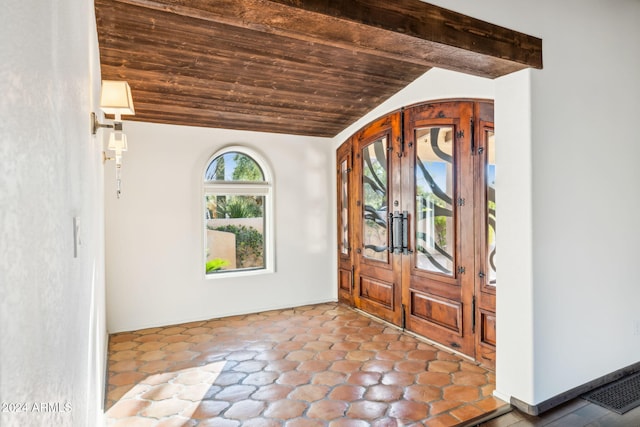 entrance foyer featuring french doors and vaulted ceiling with beams