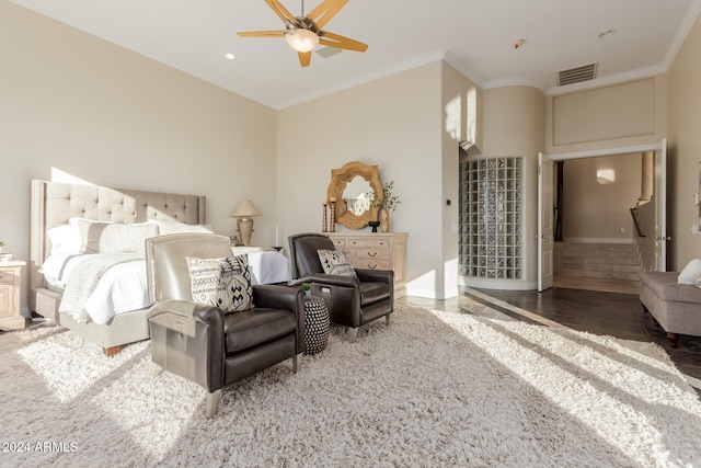 bedroom featuring dark hardwood / wood-style floors, ceiling fan, and crown molding