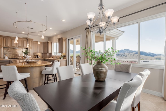 tiled dining room featuring a mountain view and a chandelier