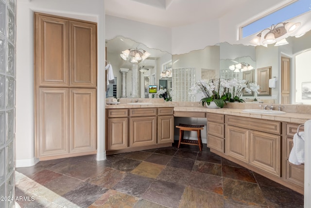 bathroom with a notable chandelier and vanity