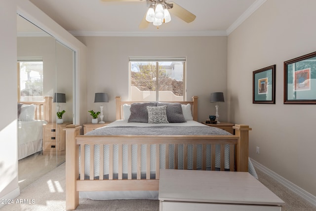 bedroom featuring ceiling fan, light colored carpet, crown molding, and a closet