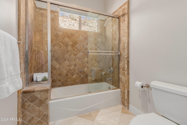 bathroom with tile patterned floors, toilet, and enclosed tub / shower combo