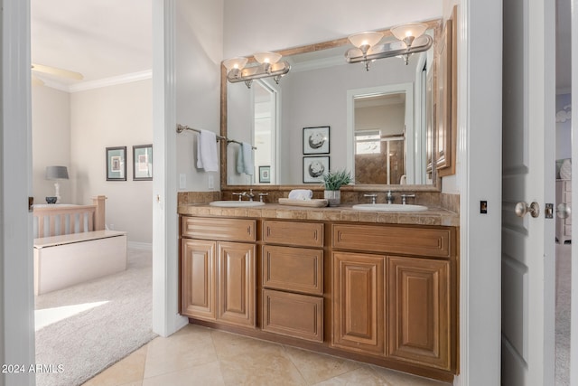 bathroom with tile patterned floors, vanity, a chandelier, and ornamental molding