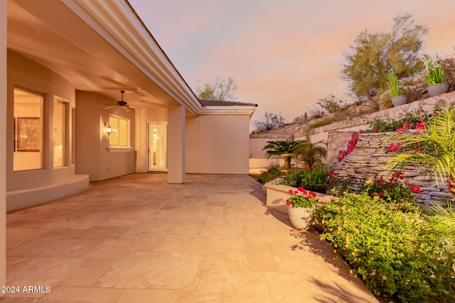 patio terrace at dusk with ceiling fan