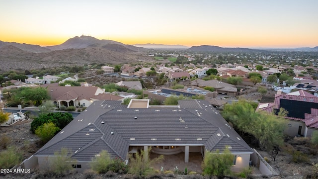 aerial view at dusk featuring a mountain view